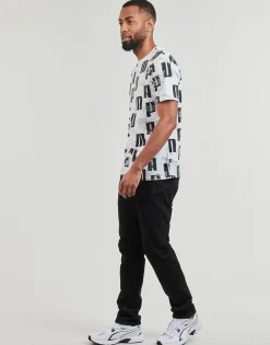 Puma T-shirts & Polos^- ESS+ LOGO LAB AOP TEE